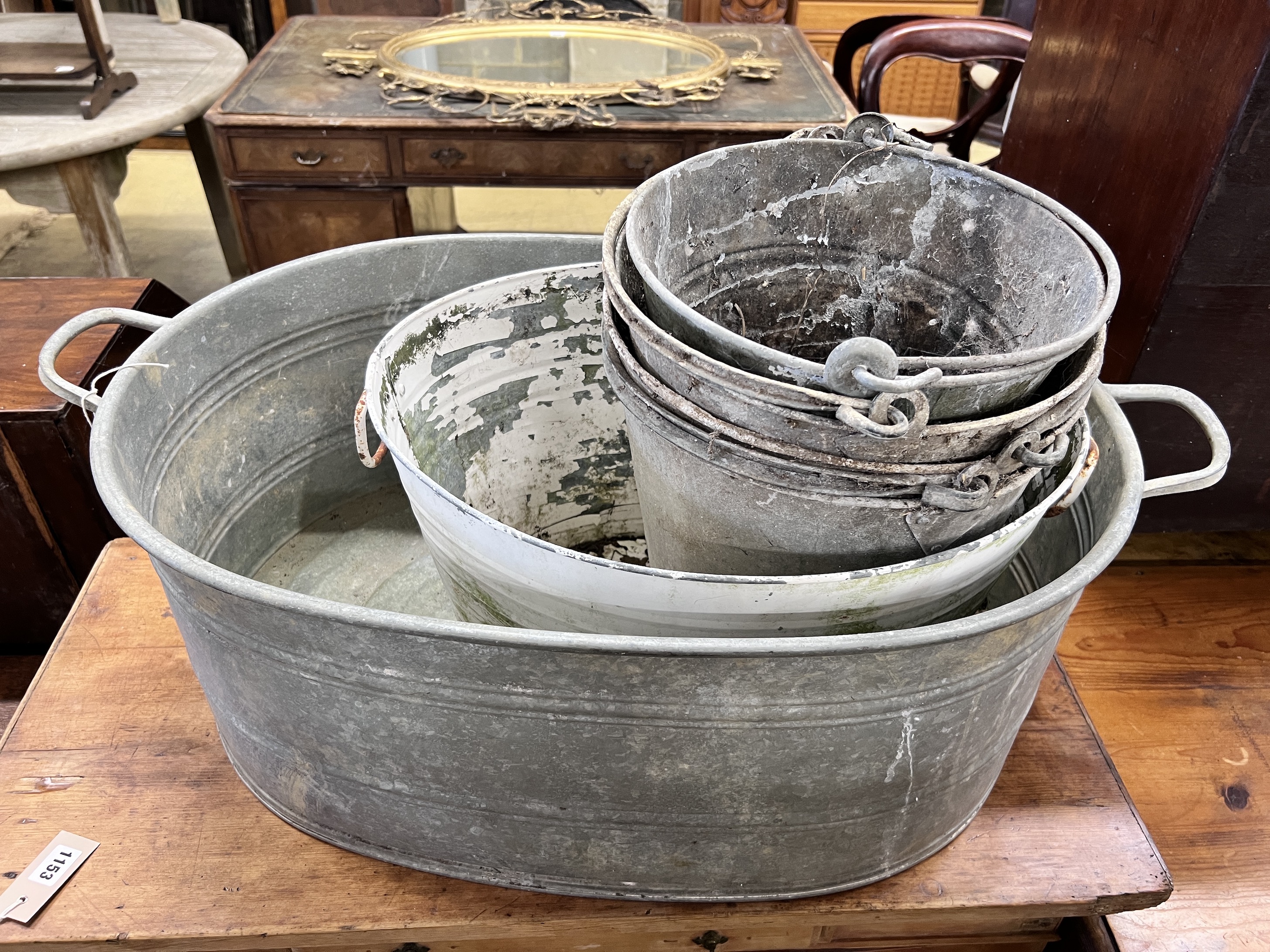 A Victorian galvanised metal wash tub, a white painted pail tub and four assorted buckets, largest 86cm